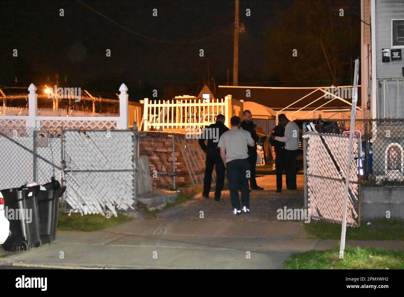 Police officers look for shell casings at the crime scene on Madison ...
