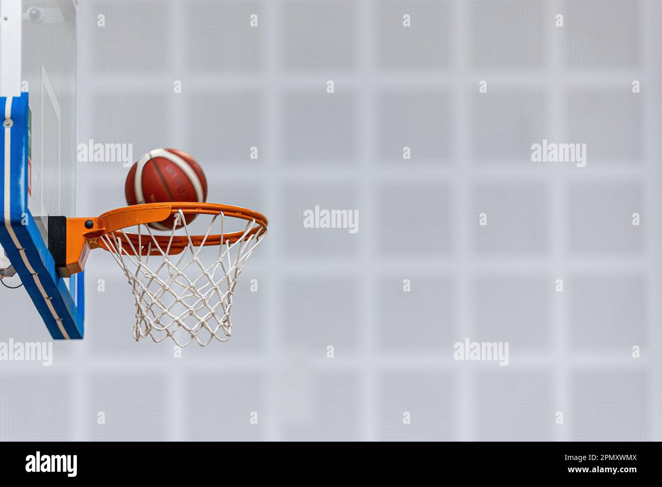 Basketball Ball On Wooden Sports Court. Junior Level Basketball Players