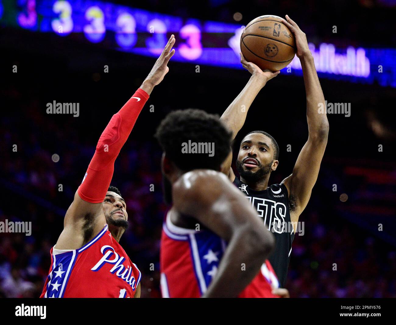 Brooklyn Nets' Mikal Bridges, right, shoots over Philadelphia 76ers
