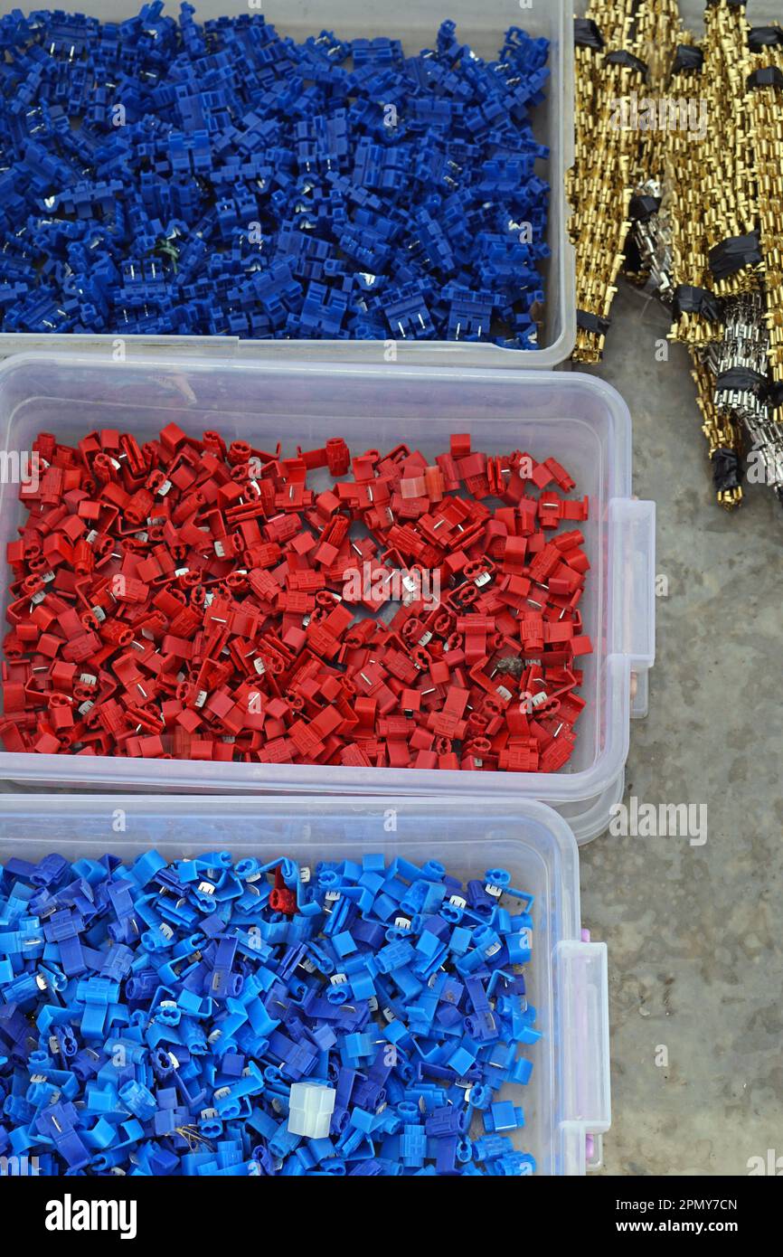 Blue and red electric terminal connectors parts in boxes Stock Photo