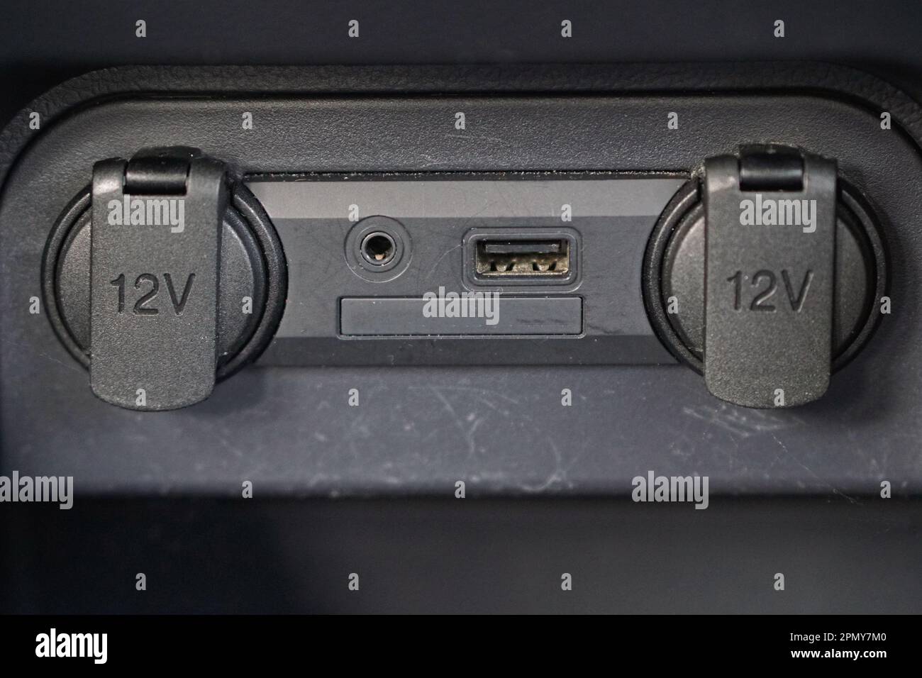 Electric sockets and audio entertainment connection in car Stock Photo