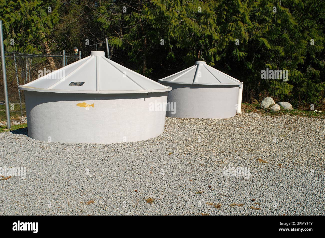 Two domed fish holding tanks on a gravel base located at the Bell-Irving Fish Hatchery - Kanaka Creek watershed - Maple Ridge, B. C.,Canada. Stock Photo