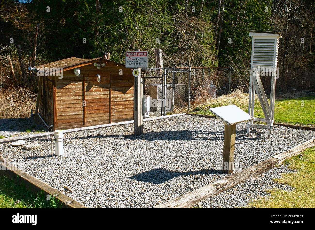 A Weather Station on a gravel base with a cedar shed located at the Bell-Irving fish hatchery - Kanaka Creek watershed - Maple Ridge, B. C., Canada. Stock Photo