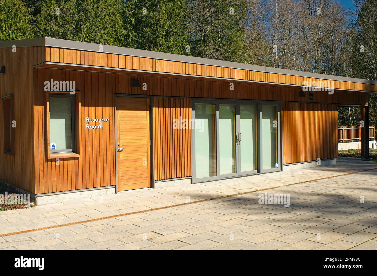 A low, cedarsided building indicating "Resource Room" with double