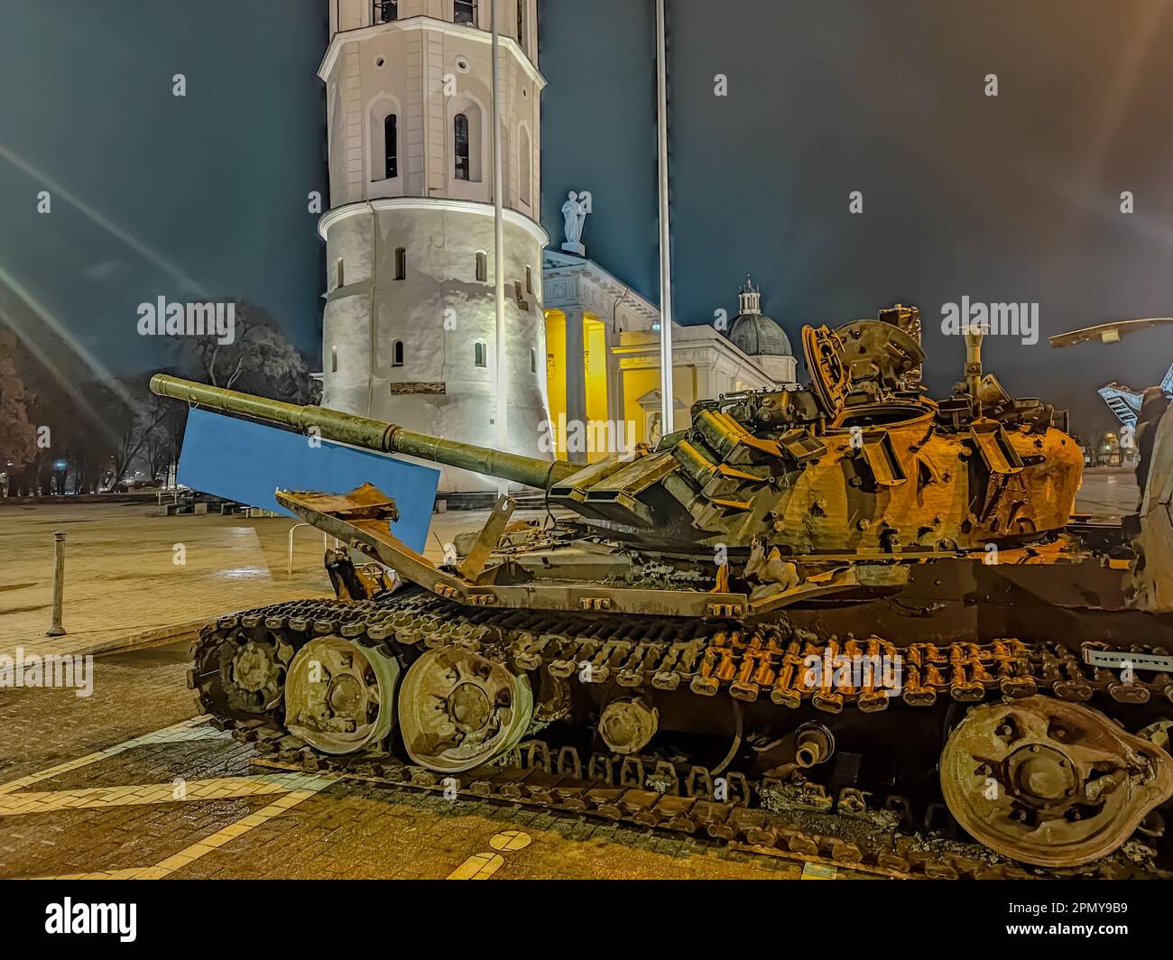 A destroyed Russian tank standing at night in the old town of Vilnius. Battle tank destroyed during hostilities in Russian invasion of Ukraine, 2022 Stock Photo