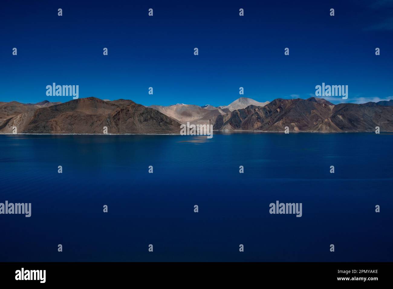 A view of Pangong Lake and surrounding mountains in Ladakh, India Stock Photo