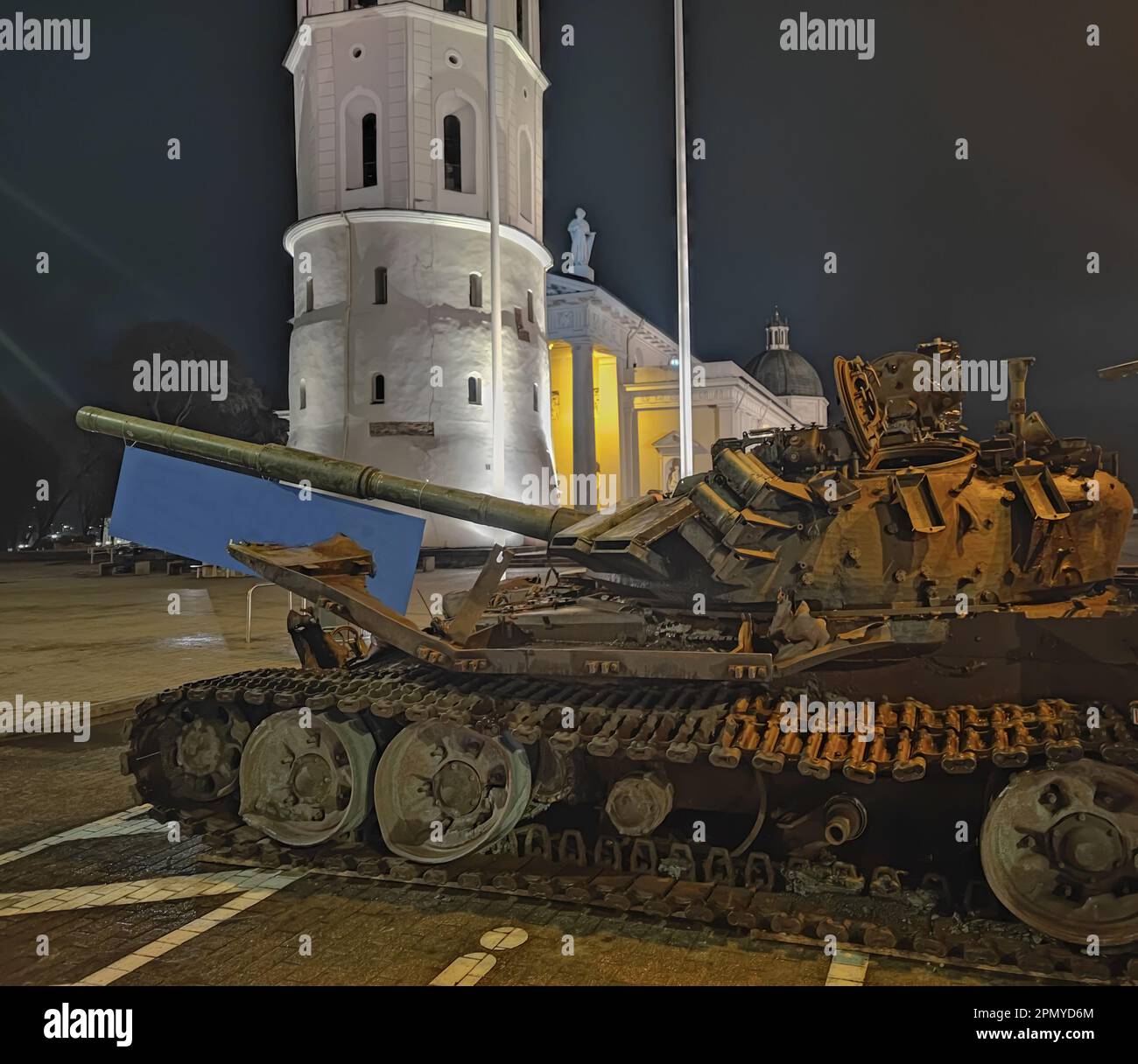 A destroyed Russian tank standing at night in the old town of Vilnius. Battle tank destroyed during hostilities in Russian invasion of Ukraine, 2022 Stock Photo
