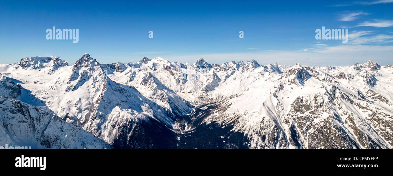 Snowy mountain peaks over the valley Stock Photo - Alamy