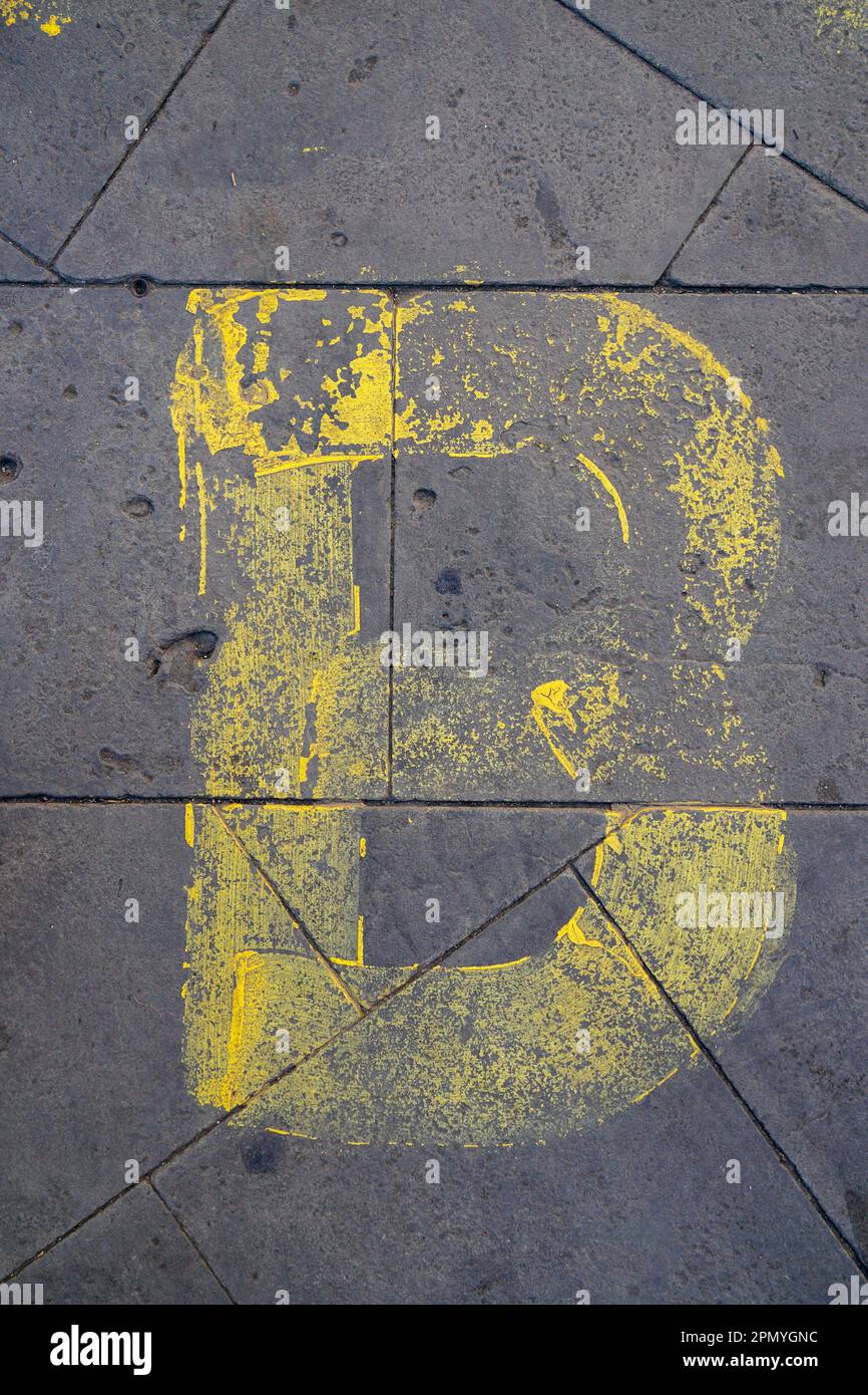 Yellow Letter B Painted On The Sidewalk Stock Photo - Alamy