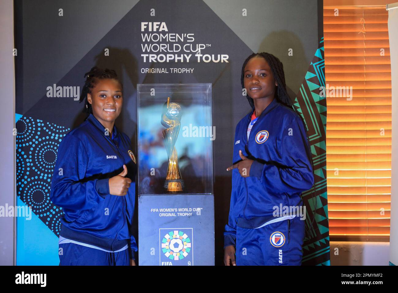 https://c8.alamy.com/comp/2PMYMF2/haitian-goalkeeper-kerly-theus-left-and-fellow-teammate-esthericove-joseph-pose-for-a-photo-alongside-the-womens-world-cup-trophy-during-a-ceremony-as-part-of-its-global-tour-in-port-au-prince-haiti-saturday-april-15-2023-a-fifa-delegation-is-traveling-with-the-trophy-to-all-32-nations-participating-in-the-soccer-tournament-which-kicks-off-on-july-20th-co-hosted-by-australia-and-new-zealand-ap-photoodelyn-joseph-2PMYMF2.jpg