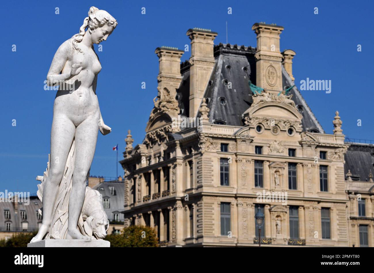 The Pavillon de Flore at the Louvre Palace in Paris is seen behind the sculpture Nymphe by Louis Auguste Lévêque, located in the Tuileries Garden. Stock Photo