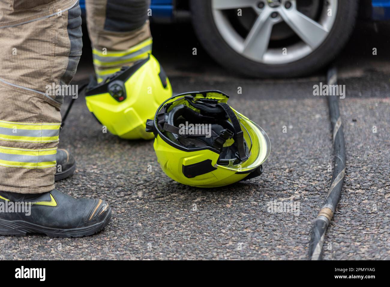 Essex County Fire & Rescue Service responding to a house fire in Westcliff on Sea, Essex, UK. Firefighter's helmets on ground Stock Photo