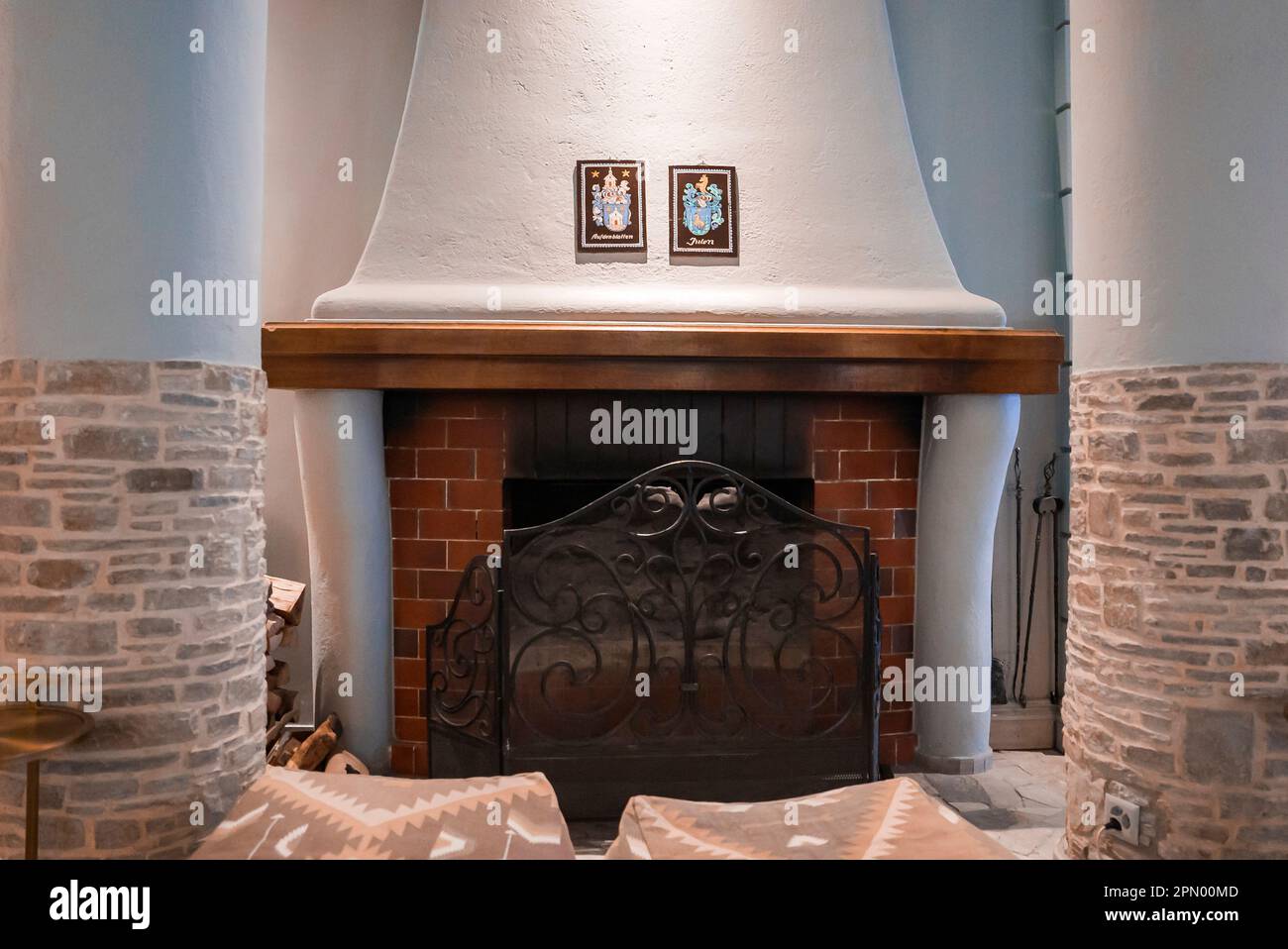 Empty ottomans in front of fireplace in hotel room Stock Photo Alamy