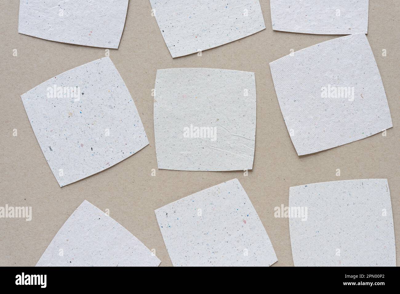 textured white paper tiles or squares with rounded corners on light 