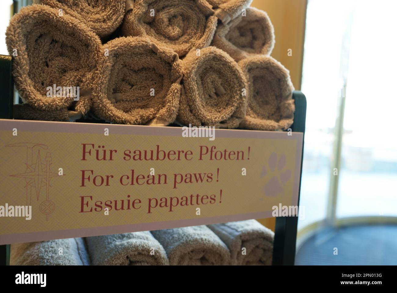 Clean white towels arranged on shelf in bathroom at luxury hotel Stock