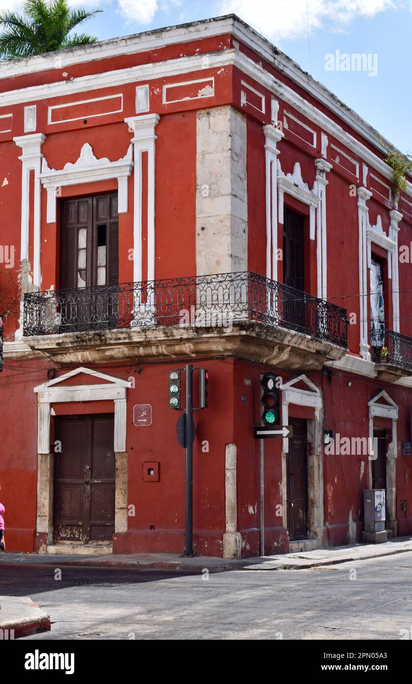 A red colonial building at the junction of calle 59 and calle 58 in the historic center of Merida, Yucatan, Mexico. Stock Photo