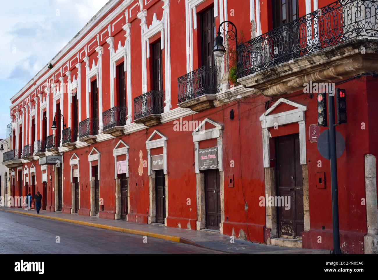 A red colonial building at the junction of calle 59 and calle 58 in the historic center of Merida, Yucatan, Mexico. Stock Photo