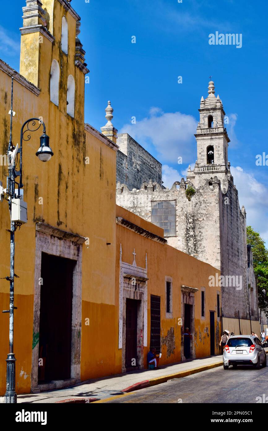 A yellow, colonial building on a street in the historic center of Merida, Yucatan, Mexico. Stock Photo