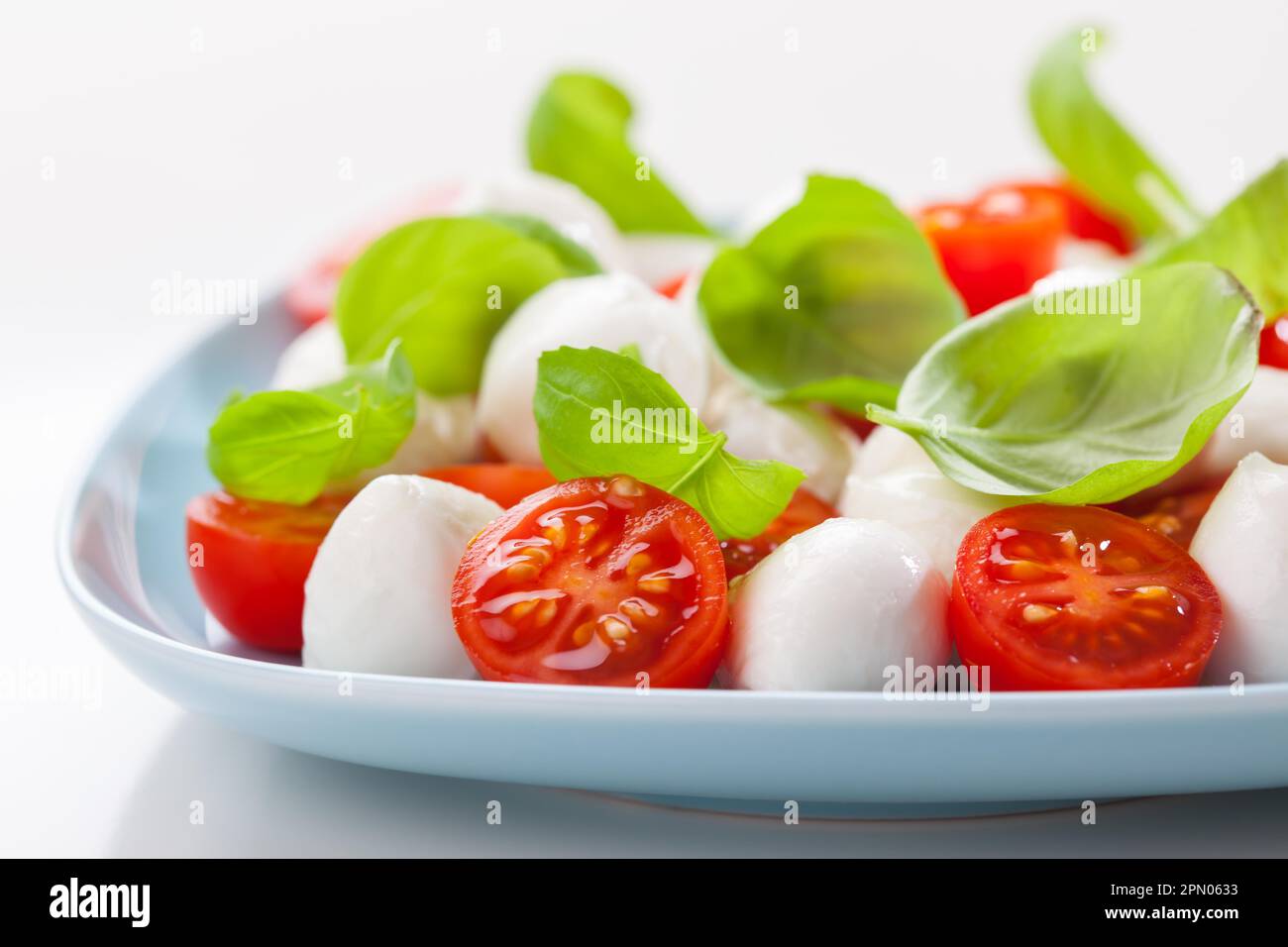 Small tomato salad with mozzarella and basil Stock Photo