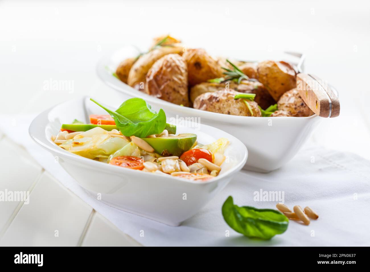 Low calorie cabbage salad with avocado and oven potatoes Stock Photo