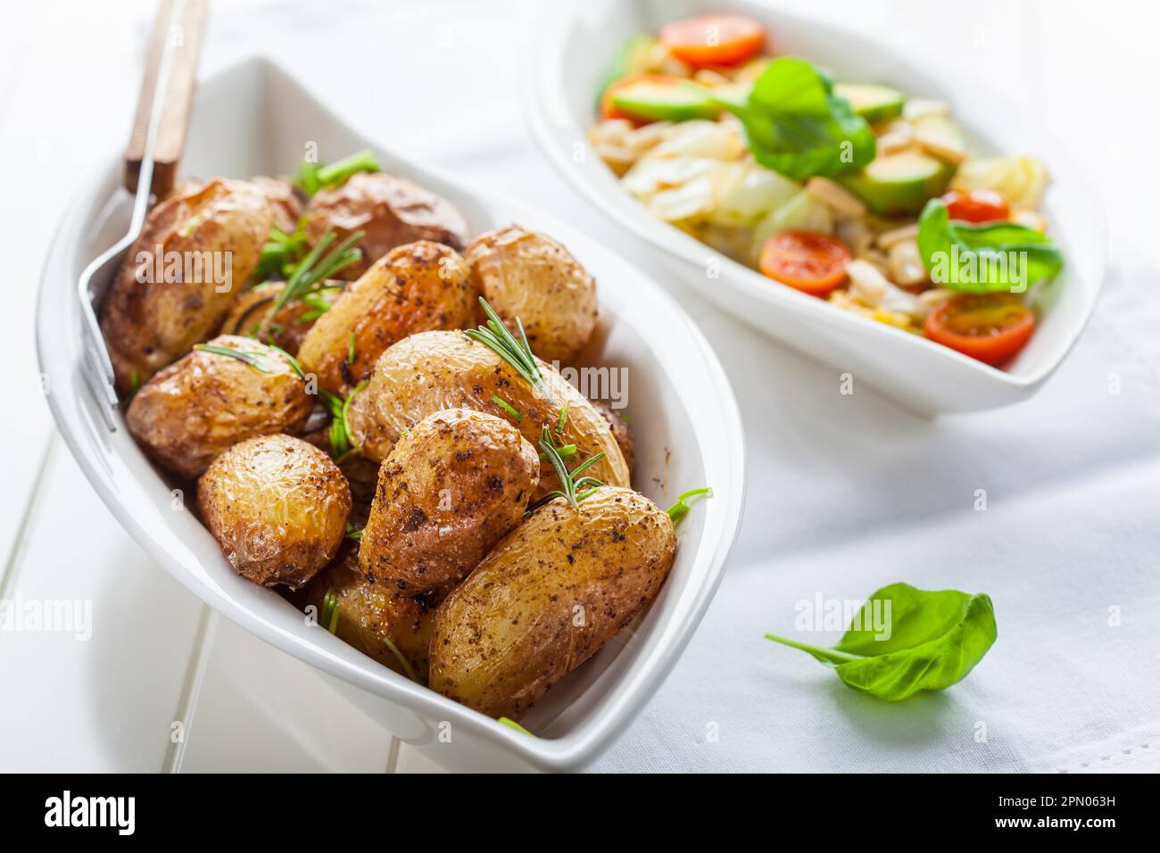 Rustic oven baked potatoes with cabbage salad Stock Photo Alamy