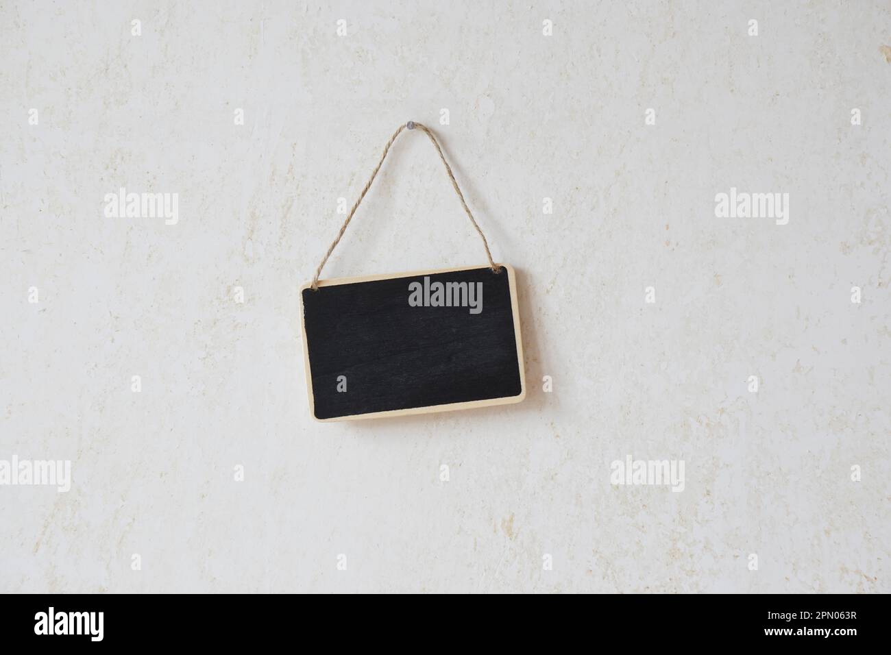 small blank chalkboard sign with piece of string hanging on nail Stock ...