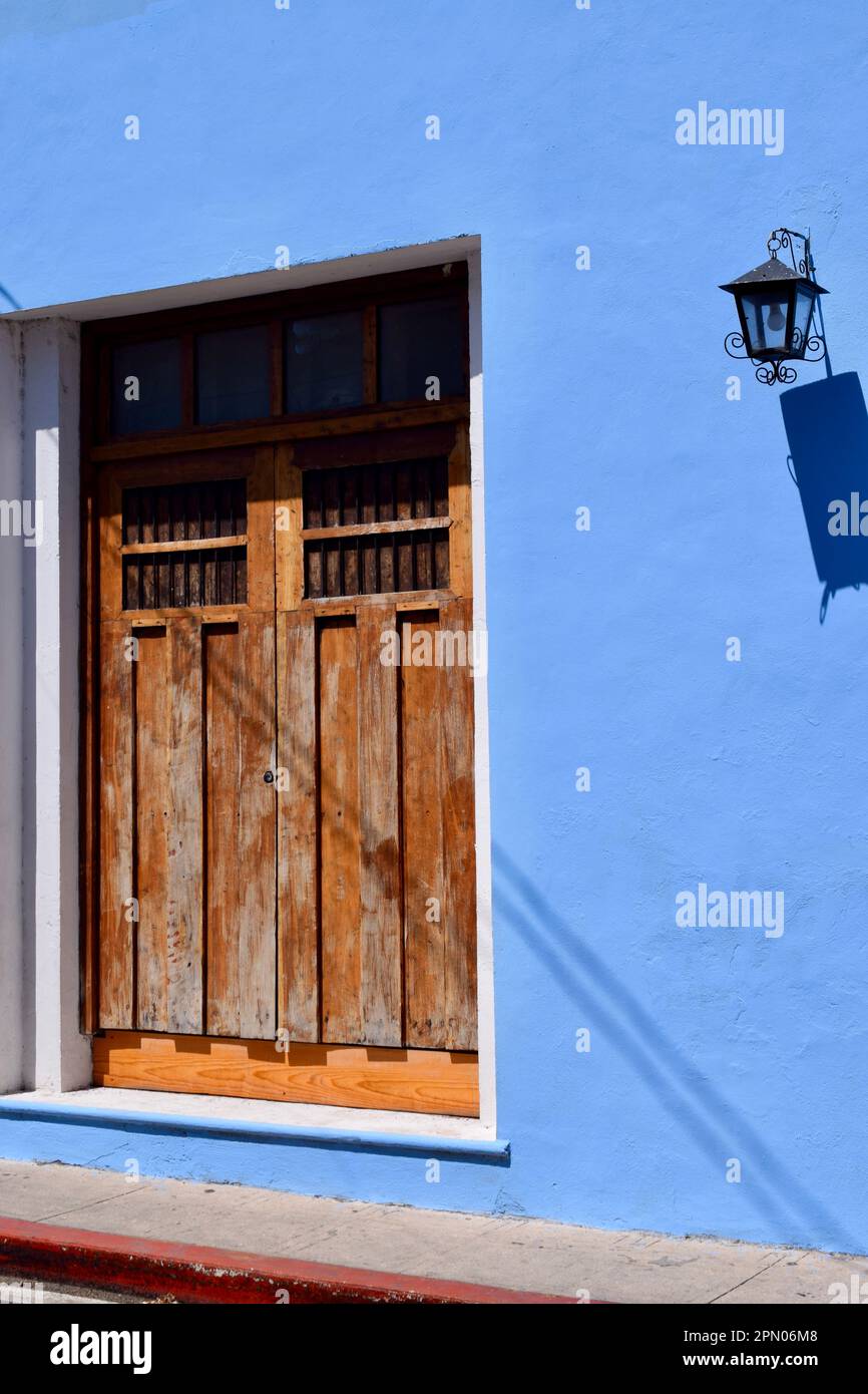 Wooden doors in a periwinkle building in the colorful city of Merida, Yucatan, Mexico. Stock Photo