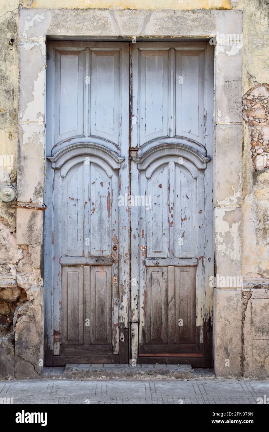 A blue, wooden door in a stone building in the historic city of Merida, Yucatan, Mexico. Stock Photo