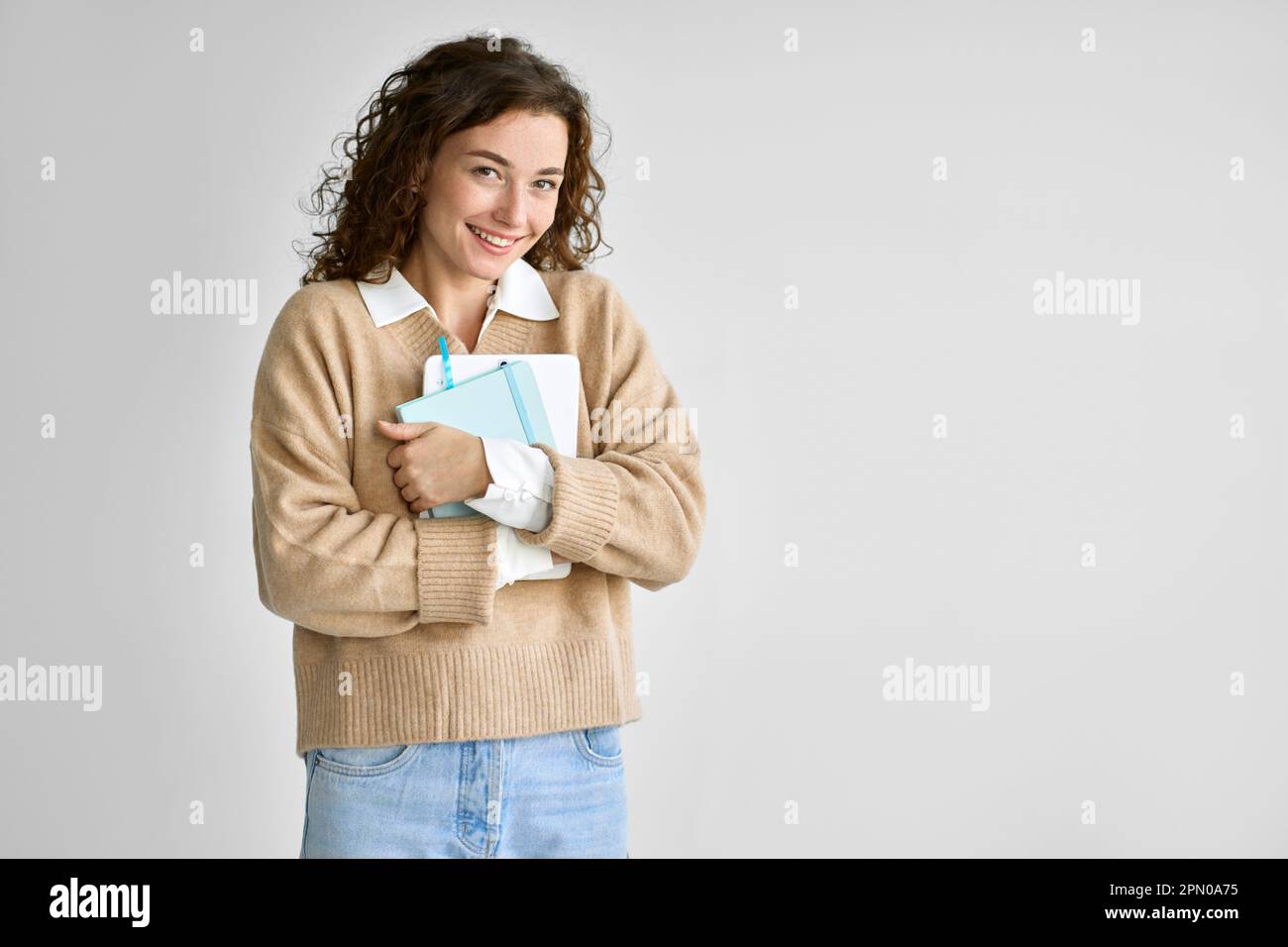 Young happy pretty cute girl student holding digital tablet isolated on white. Stock Photo