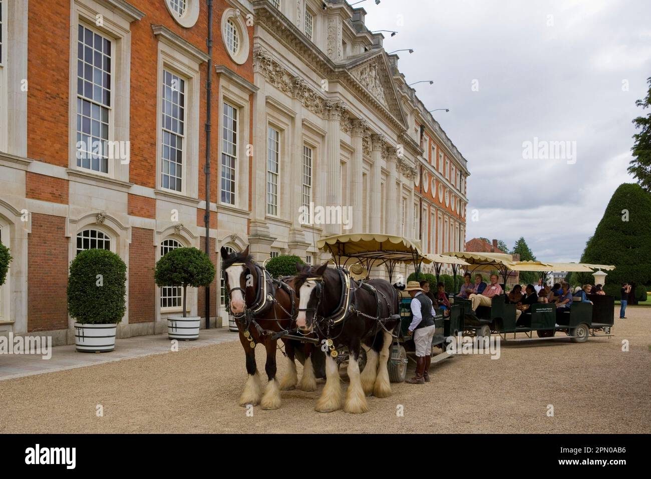 Horse, Shire horse, two working adults, pulling tourist carriage at Royal Palace, Hampton Court Palace, Richmond on the Thames, Greater London Stock Photo