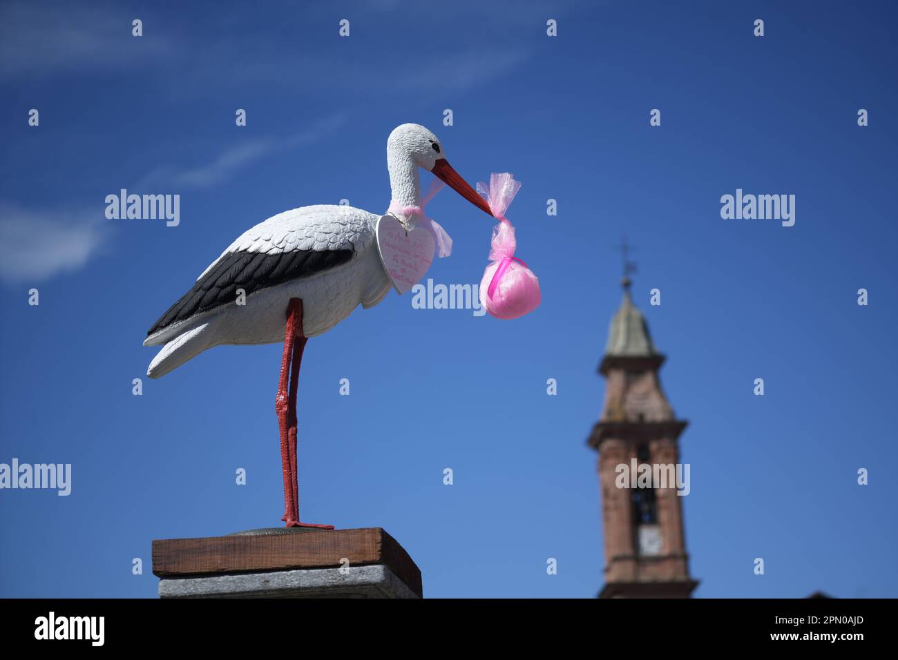 White stork announcing the birth of a baby girl. Delivery of a newborn baby Stock Photo