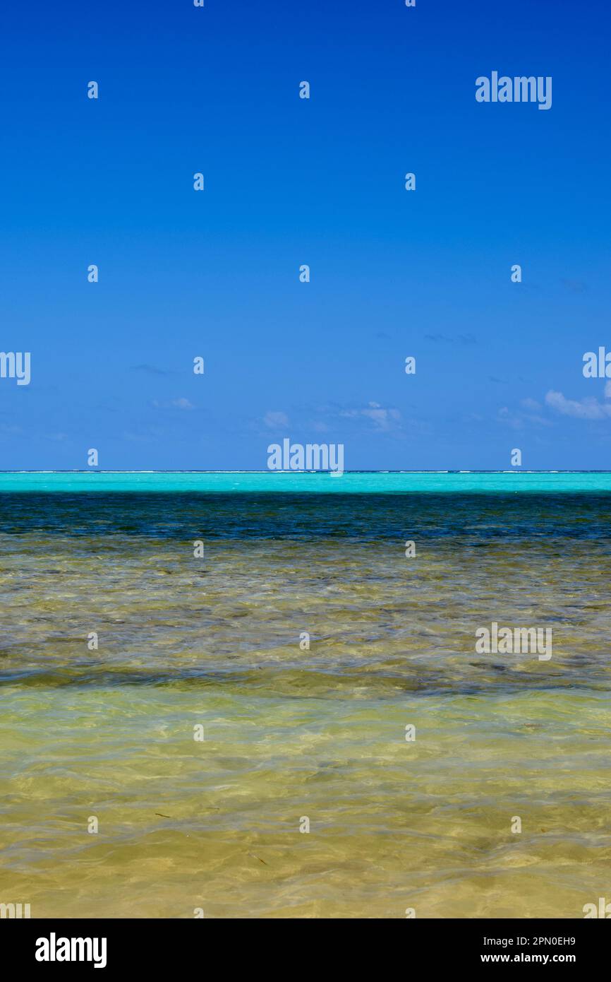 A vertical shot of clear water of various hues of blue along the beach on Ambergris Caye, Belize, Caribbean/Central America. Stock Photo