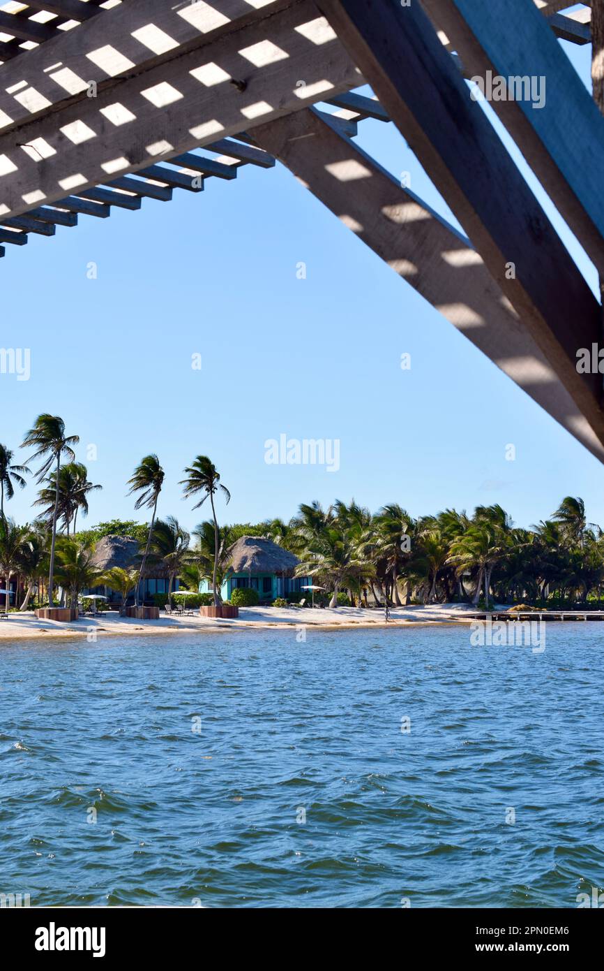 A view of the beach and some casitas, as seen from a dock, on Ambergris Caye, Belize, Caribbean/Central America. Stock Photo