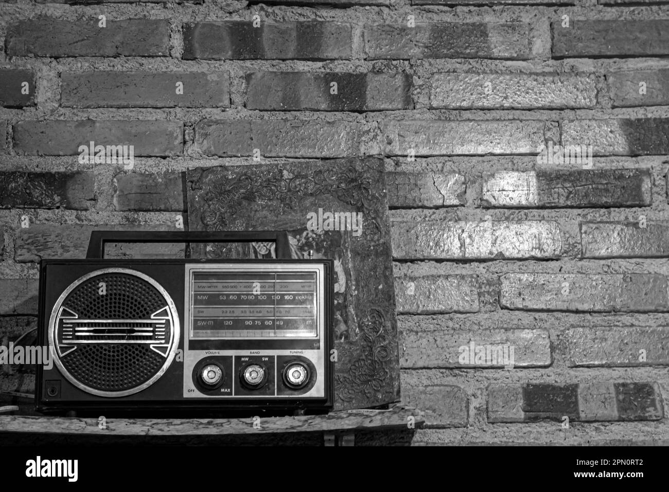 A black white vintage retro radio receiver in fornt of brick wall Stock Photo