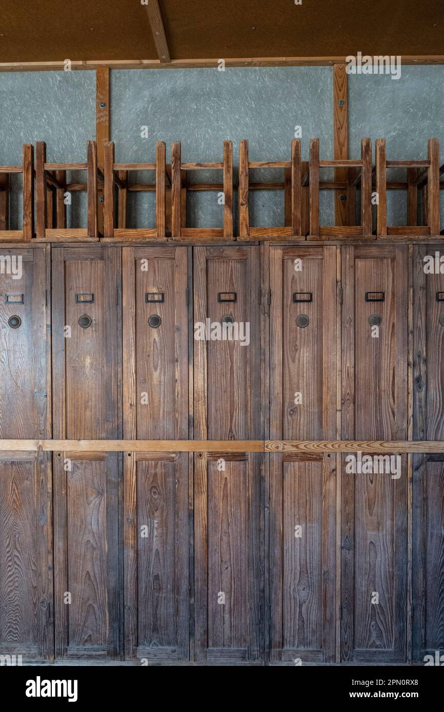 lockers where prisoners kept there belongings with stools stacked on top Stock Photo