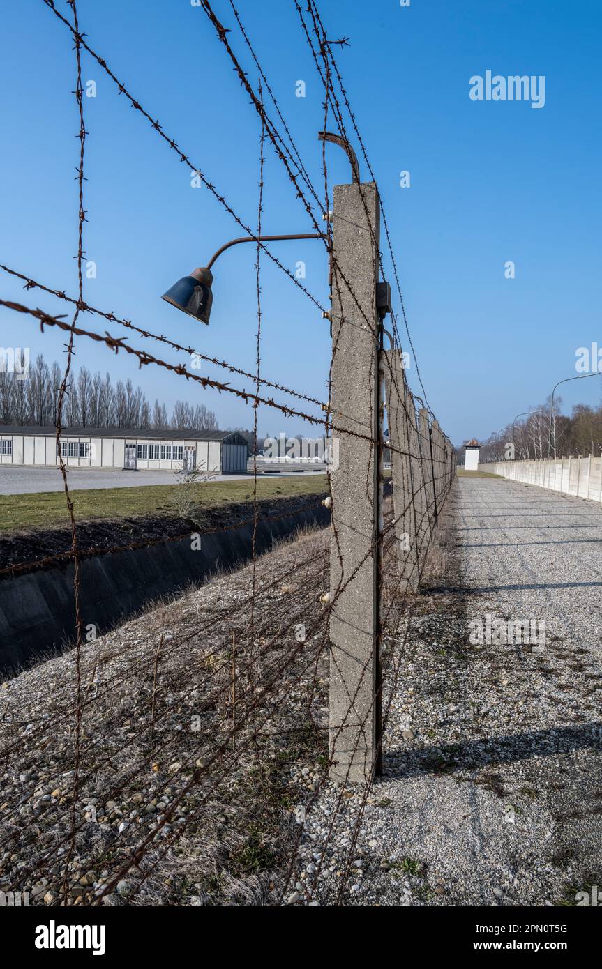 area between the concrete wall and the electrified barbed-wire fence with a ditch in front of the wired fence making escape impossible Stock Photo