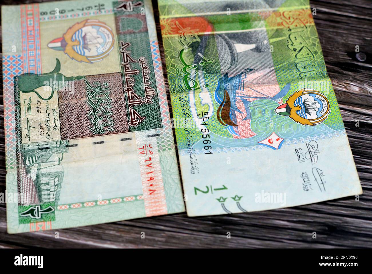 Old and new Kuwaiti half dinar bill banknotes money coat of arms of Kuwait, vignette changers' stalls, vignette of coffee pot, Kuwait Towers and a dho Stock Photo