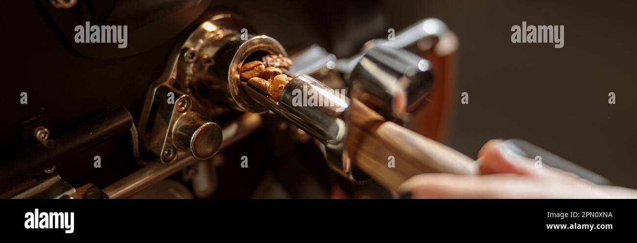 Male worker using professional coffee roasting machine Stock Photo