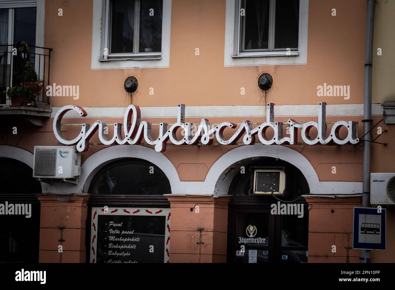 Picture of a sign with the Word gulyascsarda, a restaurant specialized in Gulash, in Szeged, Hungary. Stock Photo