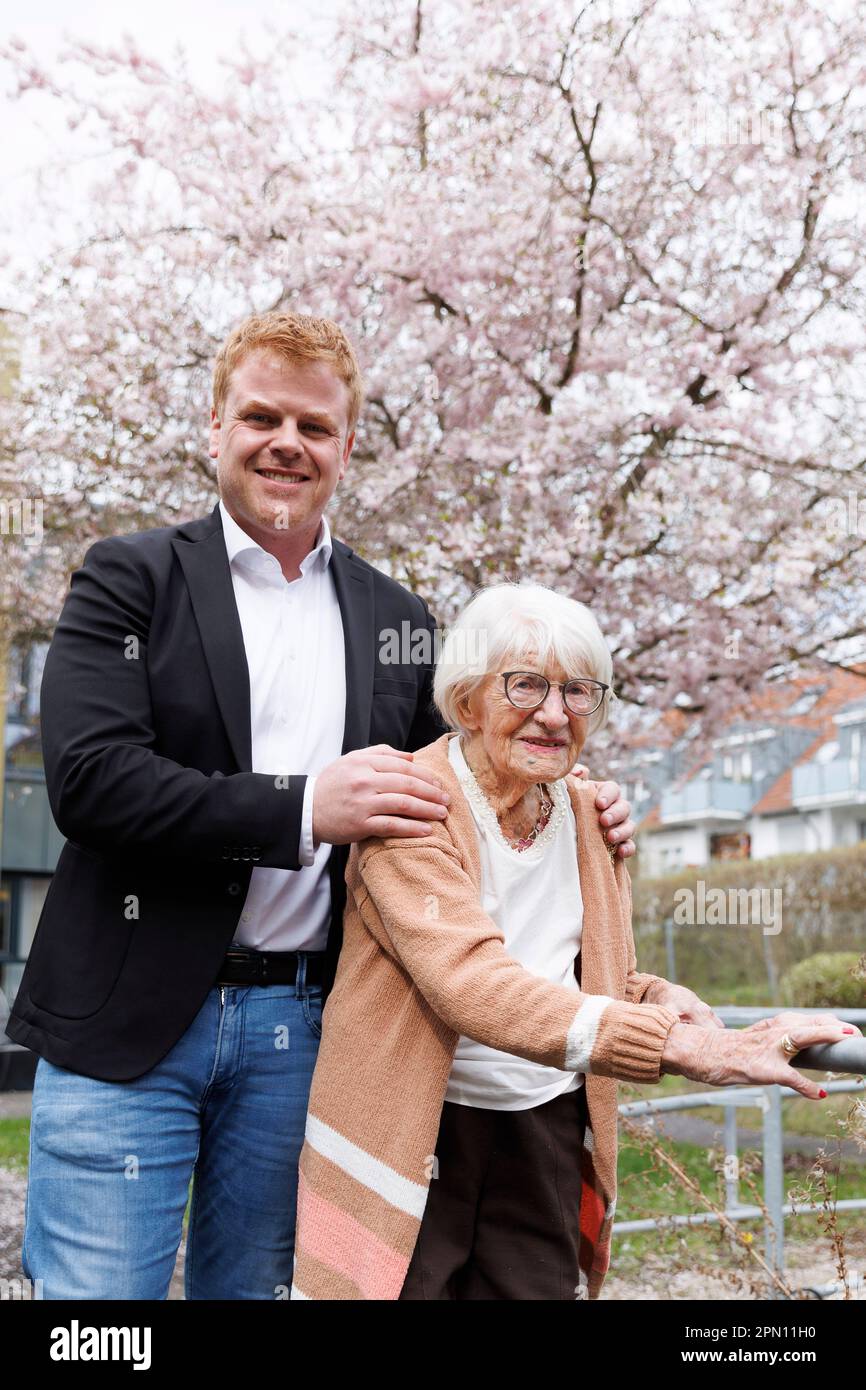 Kirchheim Unter Teck, Germany. 31st Mar, 2023. Charlotte Kretschmann stands with her grandson Peter Bauer in front of the retirement home. At 113, she is the oldest woman in Baden-Württemberg. She not only spends everyday life with her grandchildren and distant relatives, but also shares it with the world via social media. With her almost 5,000 followers, the 113-year-old shares snapshots from her life every now and then, whether it's from shopping, Christmas or an excursion. Credit: Julian Rettig/dpa/Alamy Live News Stock Photo