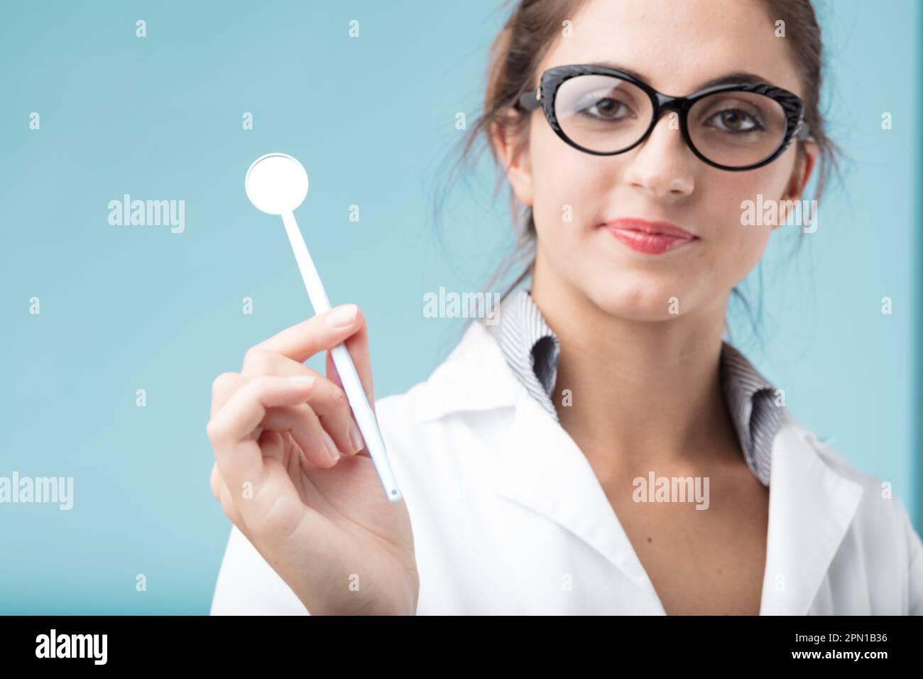 The dentist getting regular dental checkups. She holds a