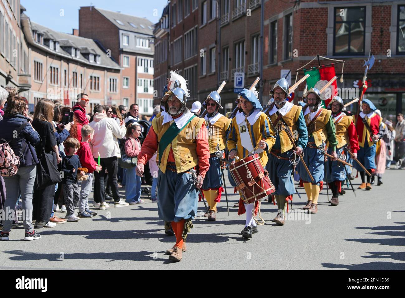 Namur, Belgium. 15th Apr, 2023. People in traditional dress march on a