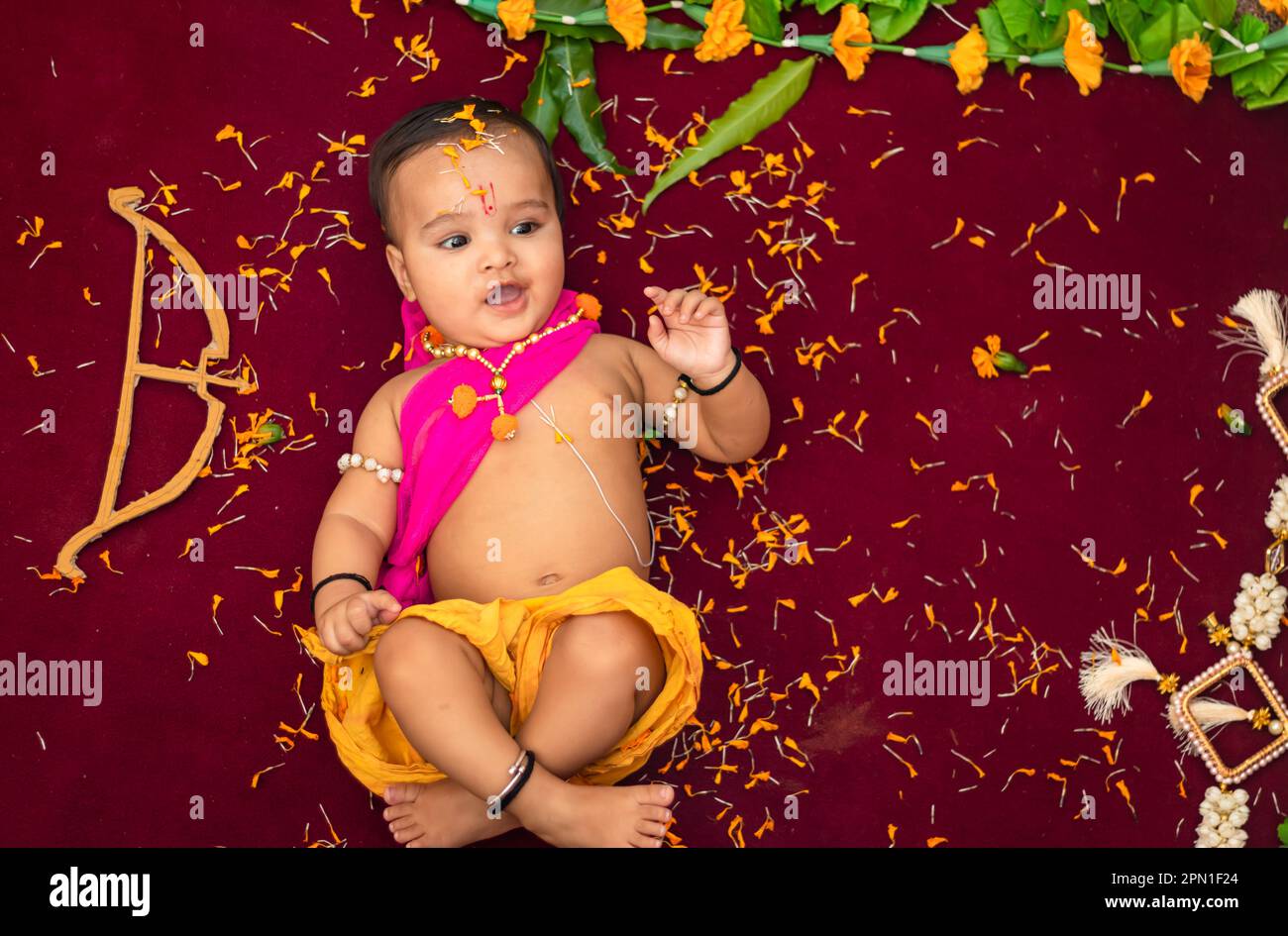 cute Indian boy dresses as lord rama with bow and flowers from top ...