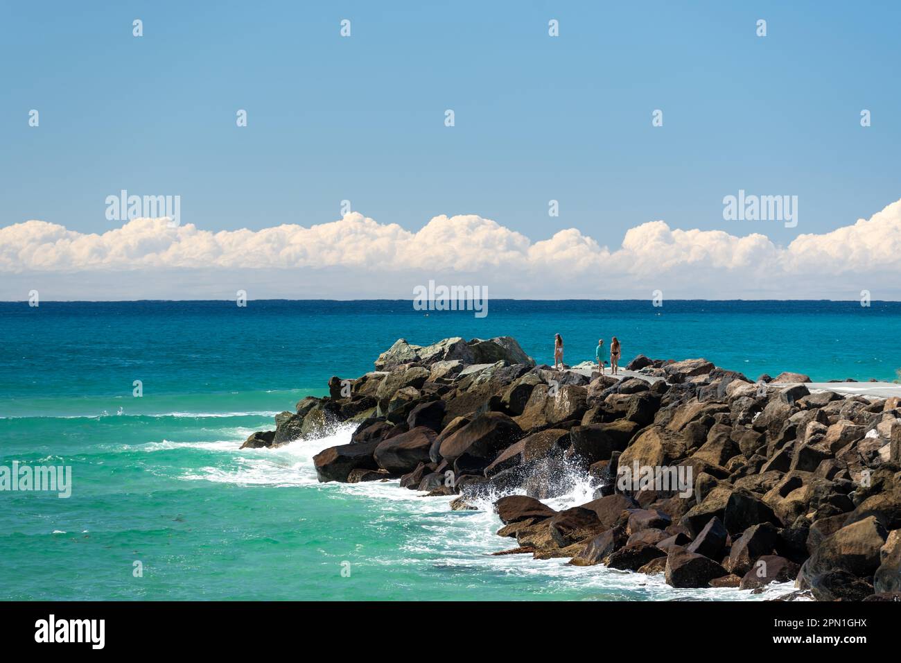 View past the Coolangatta seawall to the ocean with clouds clouds sitting low over the horizon. Coral Sea, Gold Coast, Queensland, Australia Stock Photo