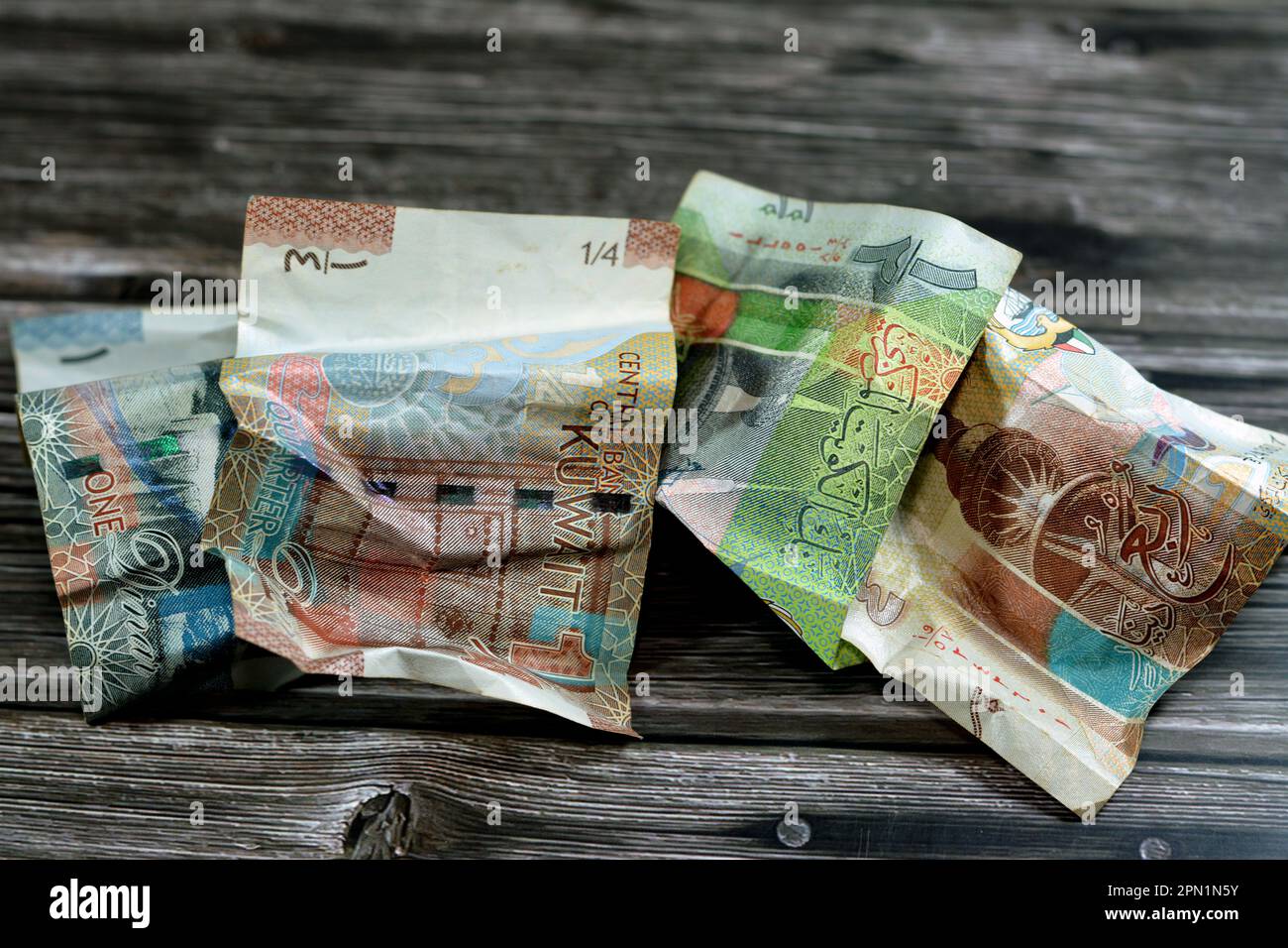 crumpled Kuwaiti money of quarter, half and one KWD Kuwait dinar bills