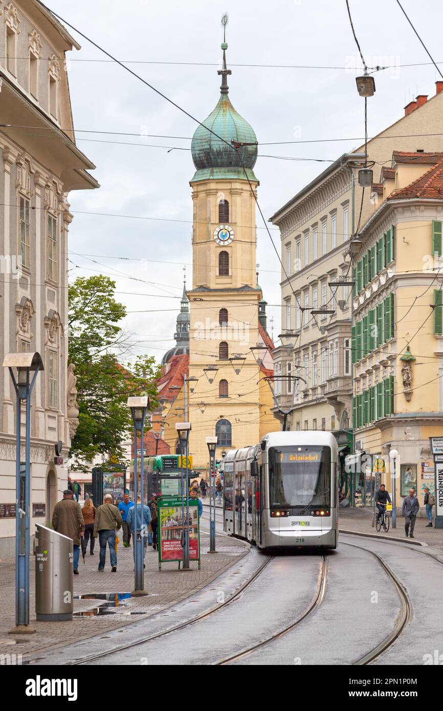 Graz, Austria - May 28 2019: Tramway coming from the Franciscan Church (Austrian: Franziskanerkirche Graz) in the city center. Stock Photo