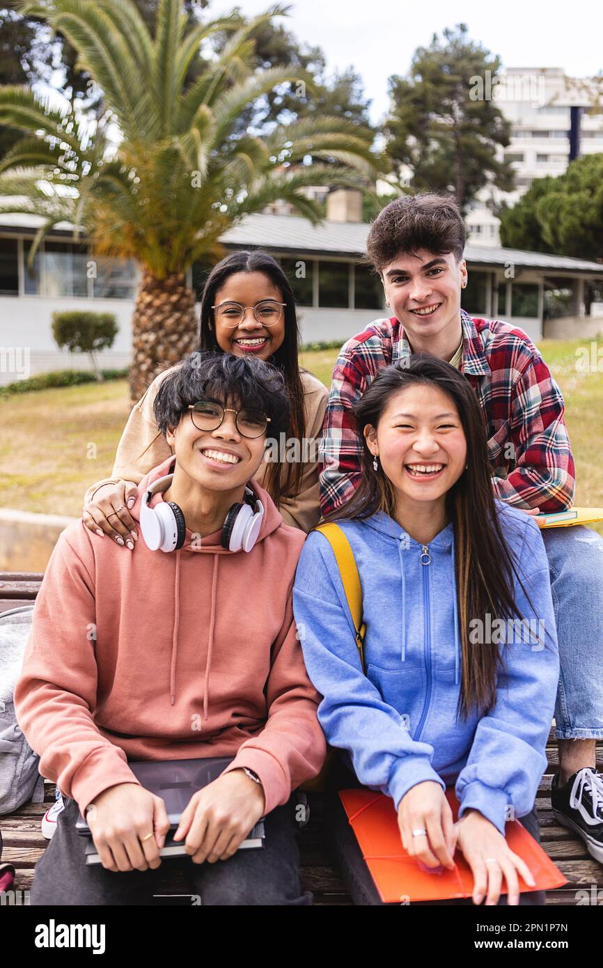 Multi ethnic portrait of young group of happy student friends smiling at camera Stock Photo