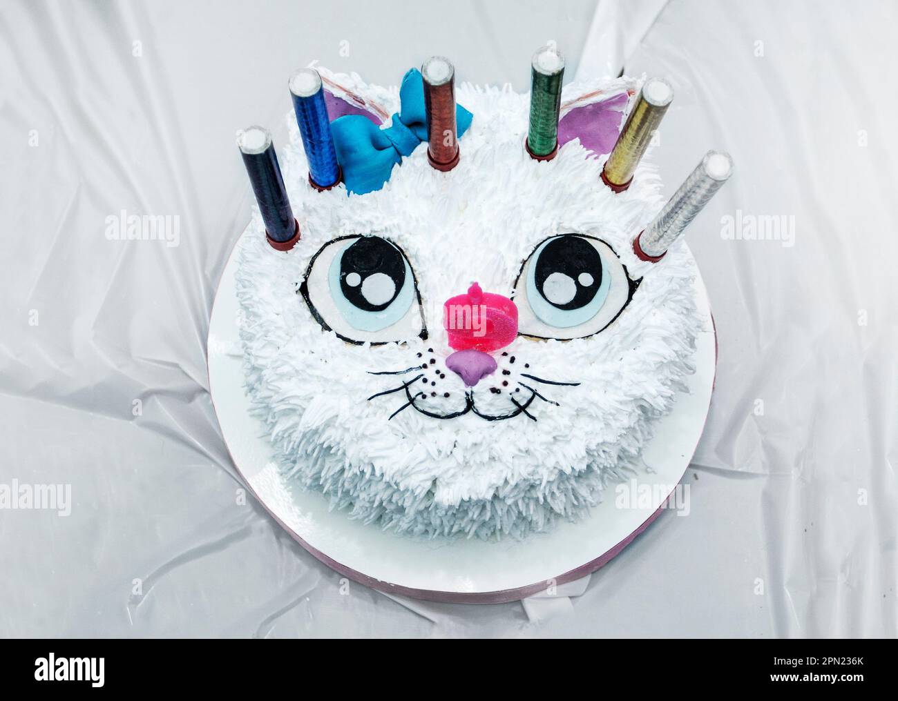 beautiful white cat cake with candles at a children's birthday ...