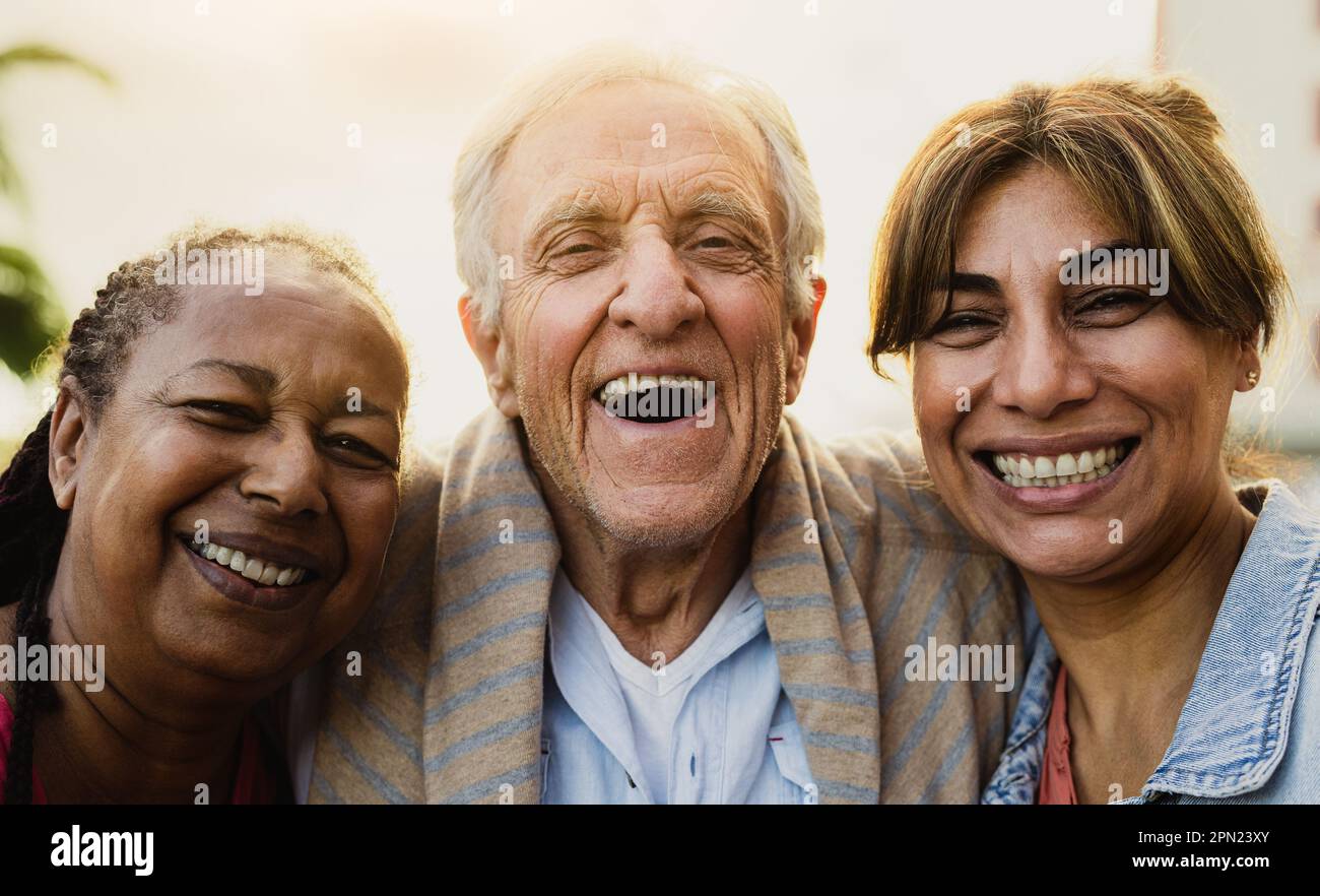 Happy multiracial people with diverse age having fun smiling in front of camera outdoor Stock Photo
