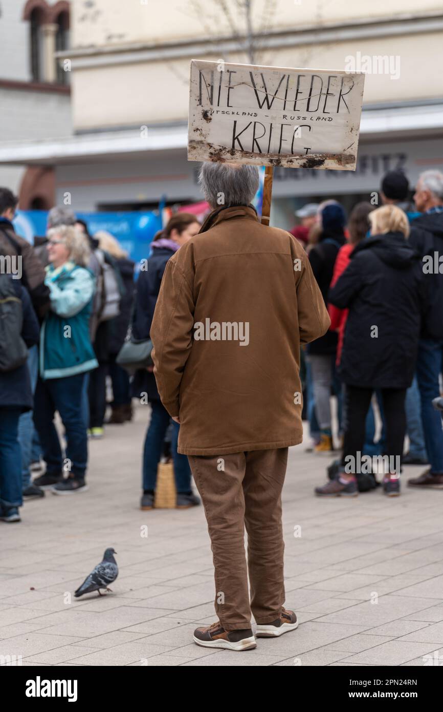 Elderly male protester standing with (anti war) sign during Easter peace demonstration at Schillerplatz on 8th Apr, 2023, Kaiserslautern, Germany Stock Photo